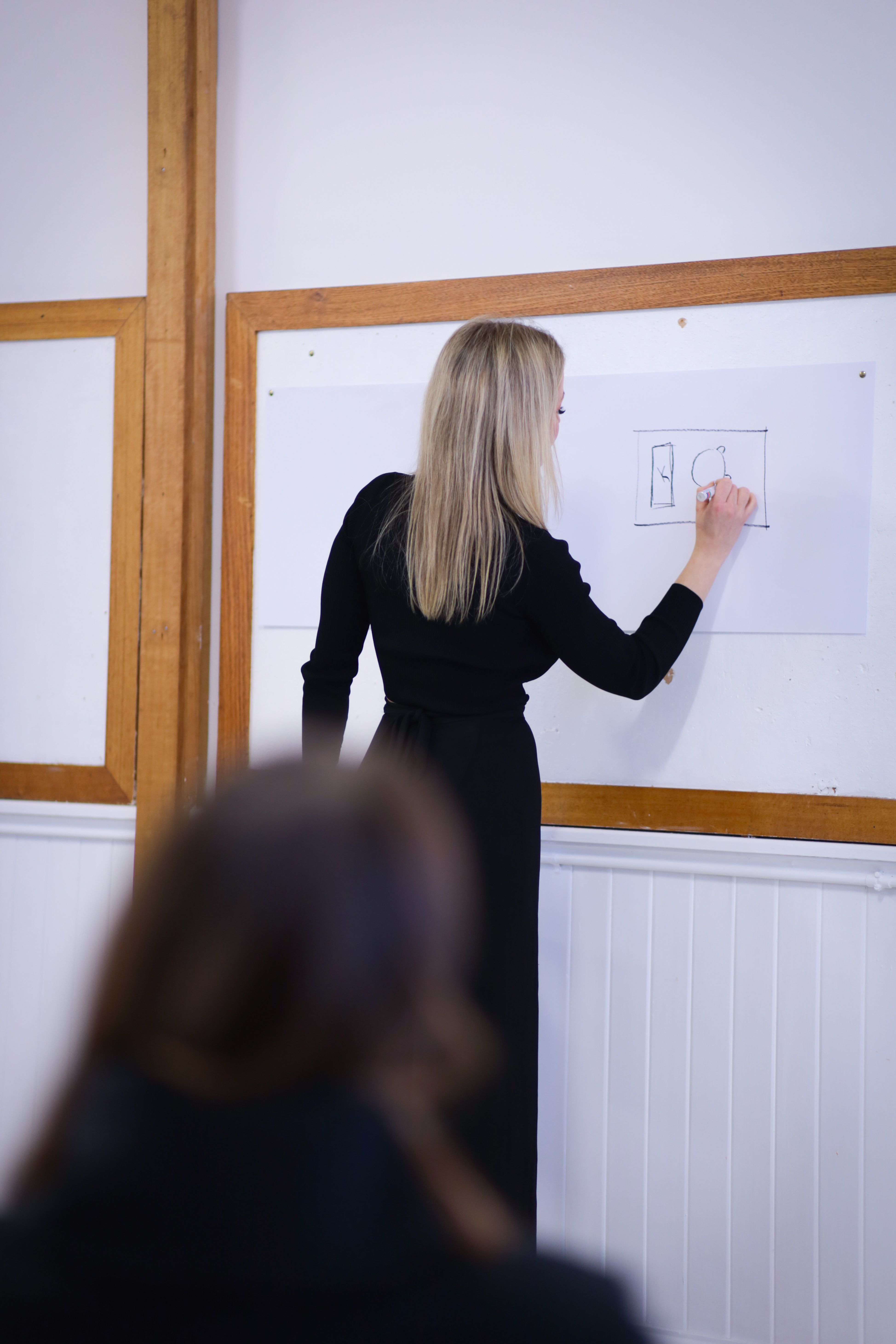 Hayley Michelle sketching a design at a workshop